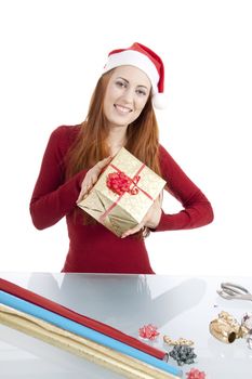 young woman is packing  present for christmas isolated on white