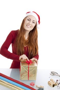 young woman is packing  present for christmas isolated on white