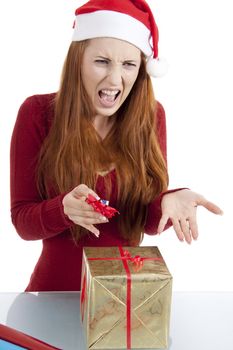 young woman is packing  present for christmas isolated on white