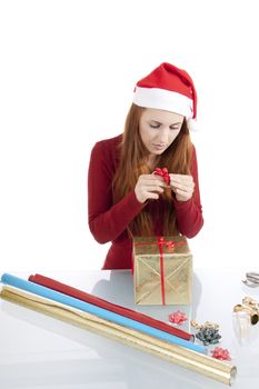 young woman is packing  present for christmas isolated on white