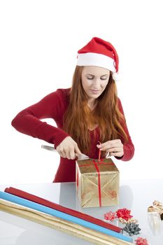 young woman is packing  present for christmas isolated on white