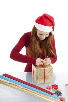 young woman is packing  present for christmas isolated on white