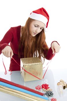 young woman is packing  present for christmas isolated on white