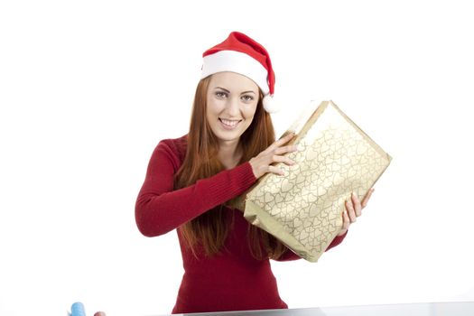 young woman is packing  present for christmas isolated on white