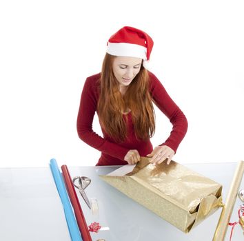 young woman is packing  present for christmas isolated on white