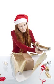 young woman is packing  present for christmas isolated on white