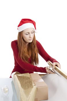 young woman is packing  present for christmas isolated on white