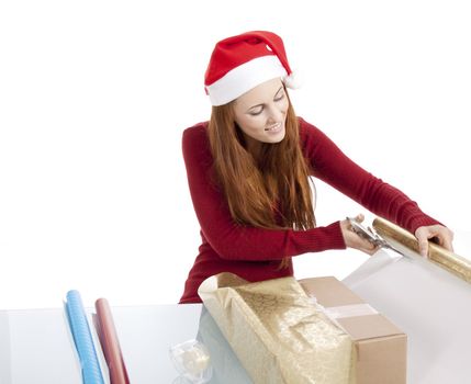 young woman is packing  present for christmas isolated on white