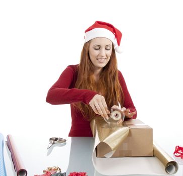 young woman is packing  present for christmas isolated on white