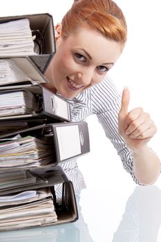 business woman in office looks at unbelievable folder stack isolated on white