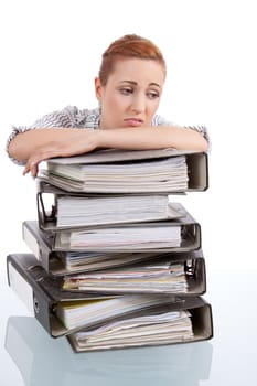 business woman in office looks at unbelievable folder stack isolated on white