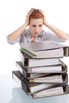 business woman in office looks at unbelievable folder stack isolated on white