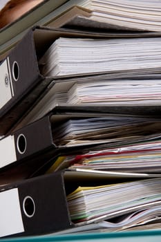 business woman in office looks at unbelievable folder stack isolated on white