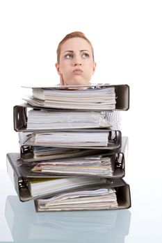 business woman in office looks at unbelievable folder stack isolated on white