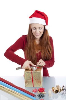 young woman is packing  present for christmas isolated on white