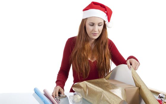 young woman is packing  present for christmas isolated on white