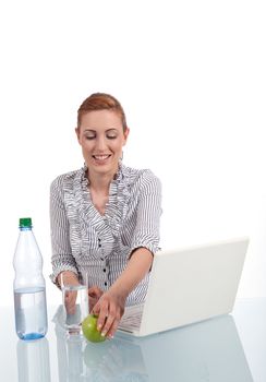 young business woman on computer with snack isolated on white