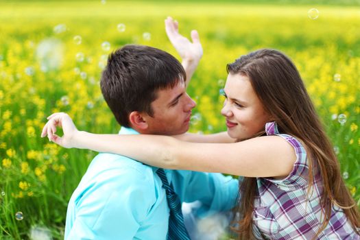 lovers hug on yellow flower field