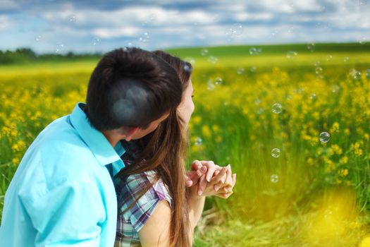 lovers hug on yellow flower field