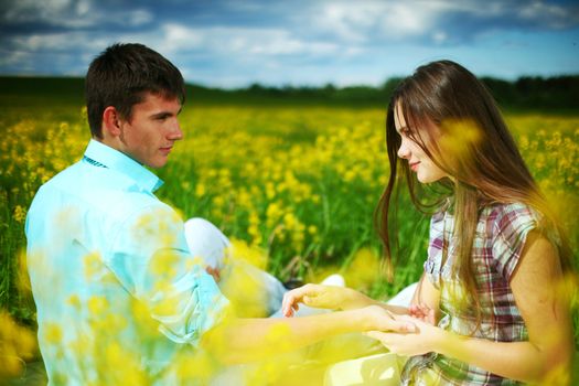 lovers hug on yellow flower field