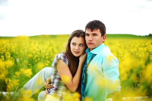 lovers hug on yellow flower field