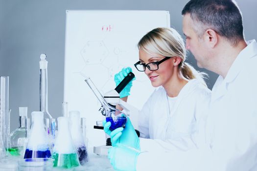  two scientist in chemical lab conducting experiments