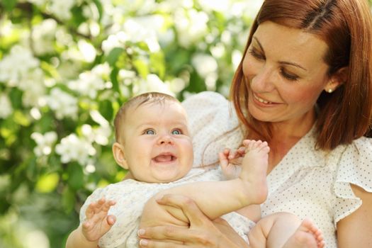 Mother and daughter close up portrait on flower background