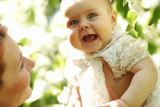 Mother and daughter close up portrait on flower background