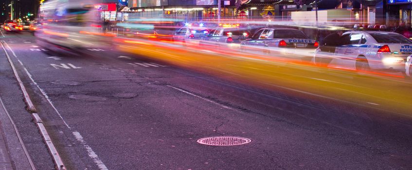 Abstract motion blur of a city street scene with a yellow taxi cabs speeding by in Manhattan