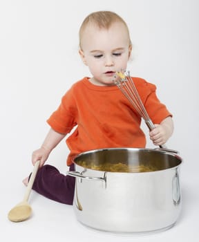 baby with big cooking pot on neutral grey background