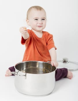 baby with big cooking pot on neutral background