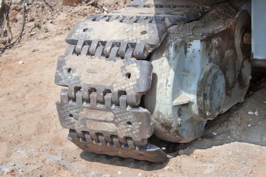Caterpillar excavator standing on ground in career