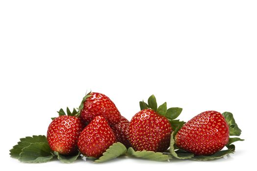 Strawberries with their leaves isolated on a white background