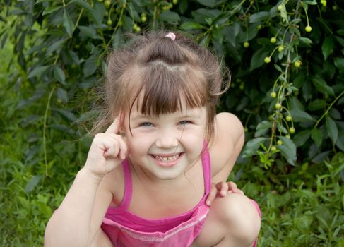 The little girl playfully twists his finger to his temple