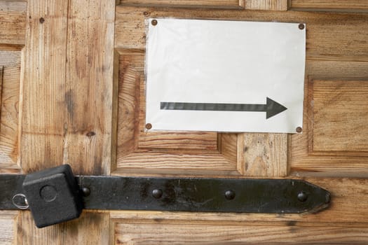 Lock on a wooden barn doors and a note by