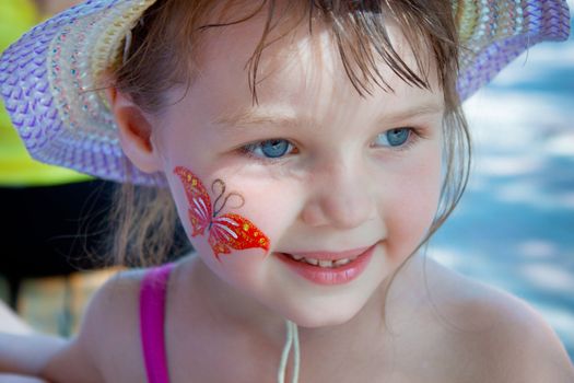 Body art on the cheek of a little girl