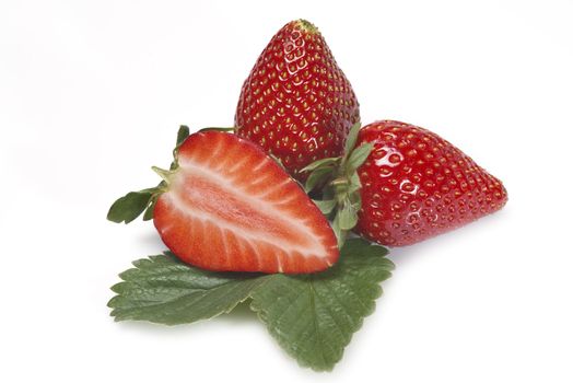 Strawberries with their leaves isolated on a white background