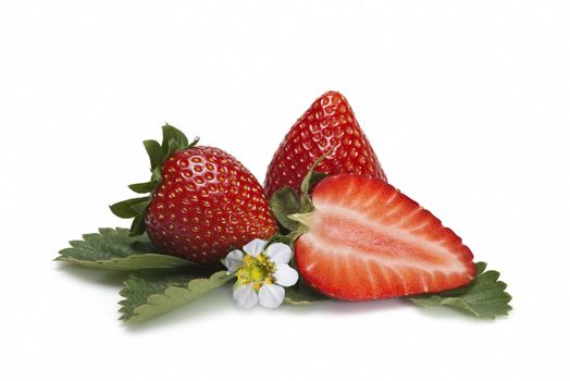 Strawberries with their leaves isolated on a white background