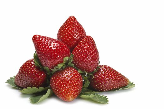 Strawberries with their leaves isolated on a white background