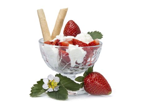 Strawberries and whipped cream cup isolated over a white background.