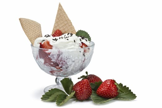 Strawberries and whipped cream cup isolated over a white background.