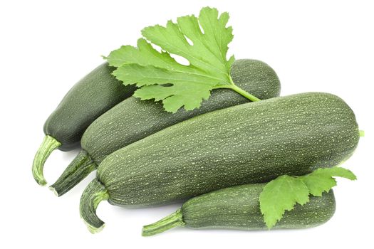Four large courgettes on a white background 