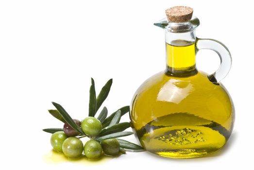 A jar with olive oil and some green olives isolated over a white background.