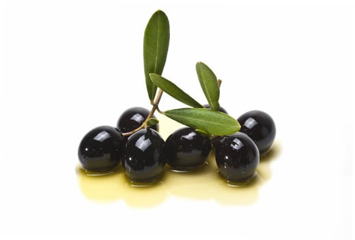 Olives covered in oil over a white background.