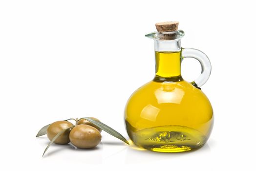 A jar with olive oil and some green olives isolated over a white background.