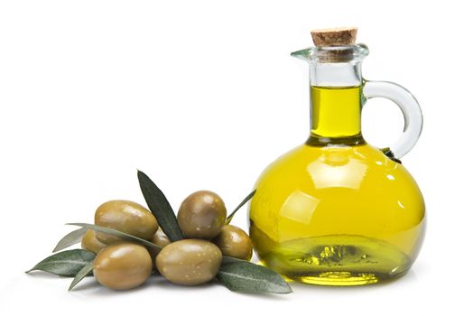 A jar with olive oil and some green olives isolated over a white background.