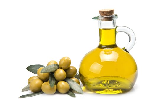 A jar with olive oil and some green olives isolated over a white background.