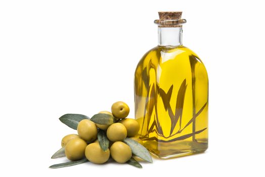 A jar with olive oil and some green olives isolated over a white background.