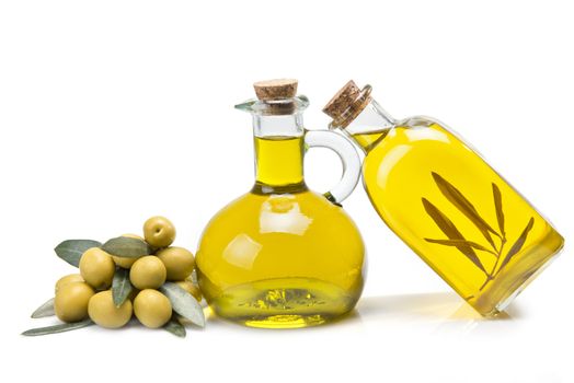 Jars with olive oil and some olives isolated over a white background.