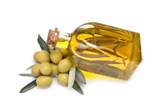 A jar with olive oil and some green olives isolated over a white background.